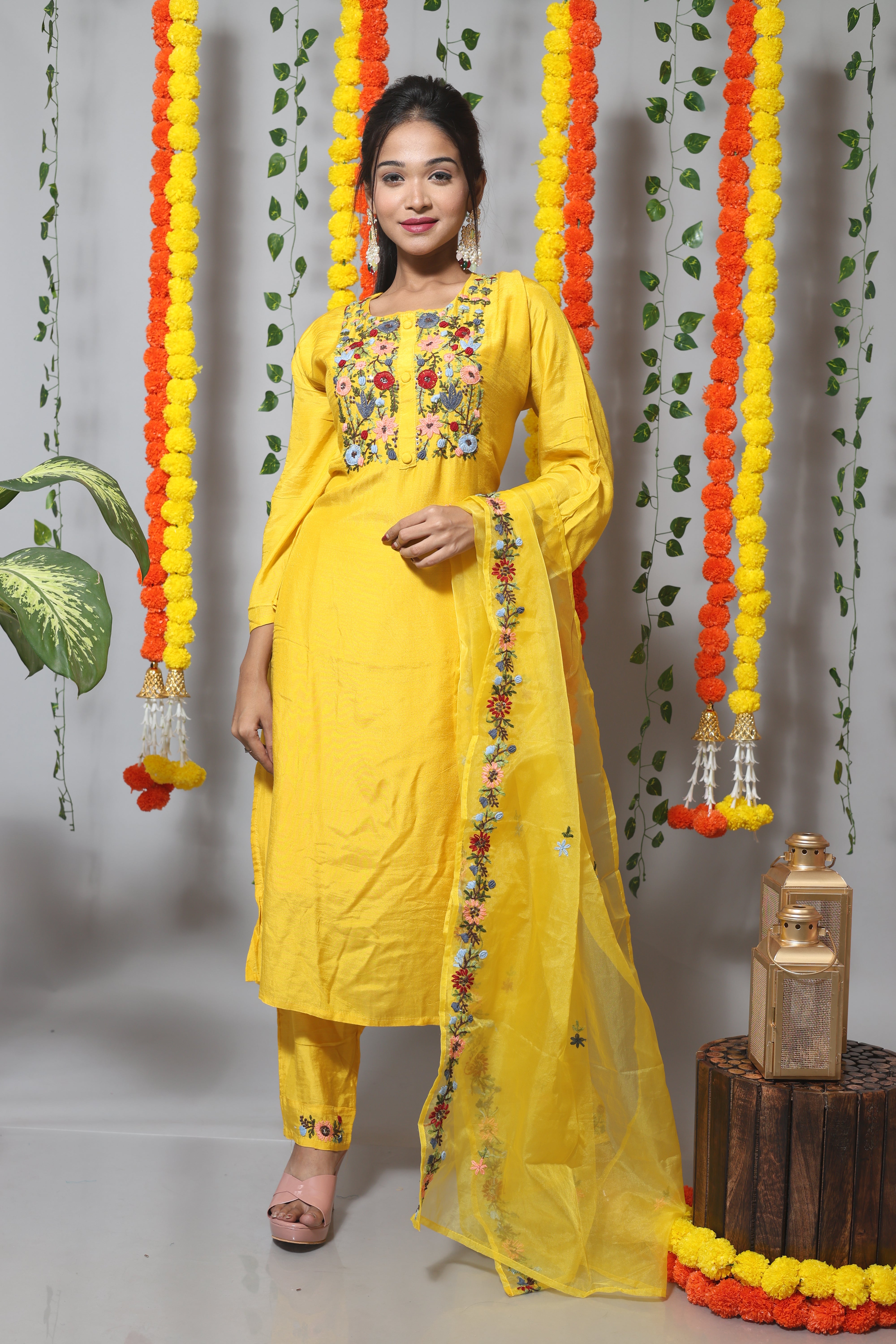 Yellow muslin suit set featuring intricate handwork