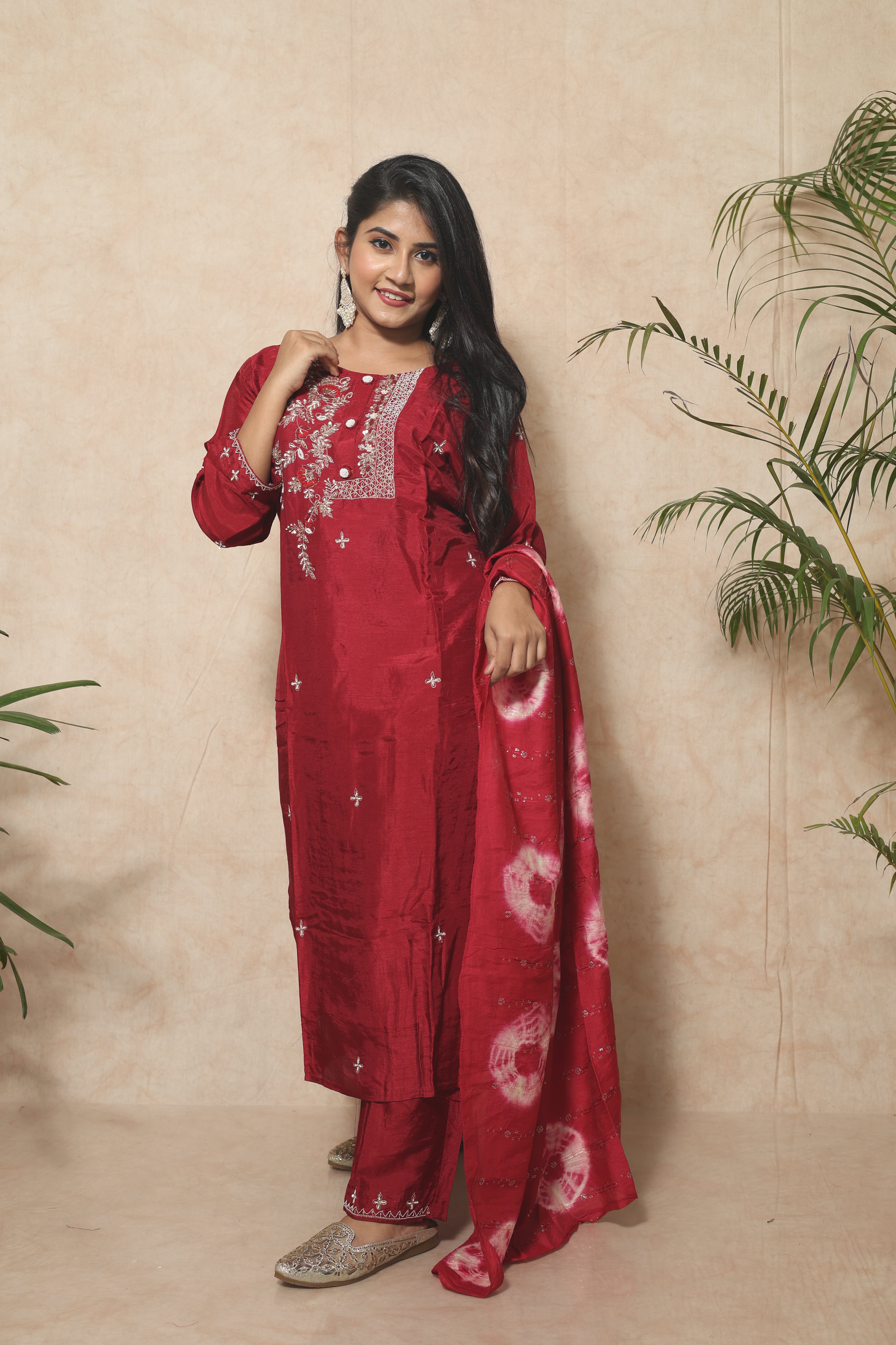 Red dola silk suit set featuring intricate handwork